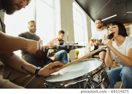 Musician band jamming together in art workplace with instruments Musician band jamming together in art workplace with instruments 69314875