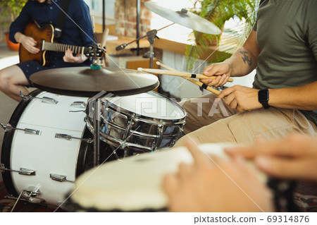 Musician band jamming together in art workplace with instruments Musician band jamming together in art workplace with instruments 69314876