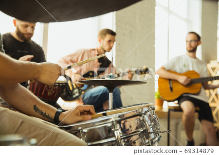 Musician band jamming together in art workplace with instruments Musician band jamming together in art workplace with instruments 69314879