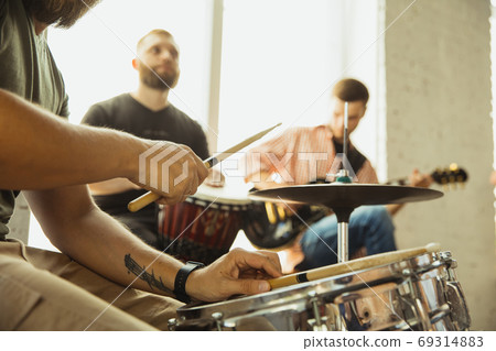 Musician band jamming together in art workplace with instruments Musician band jamming together in art workplace with instruments 69314883