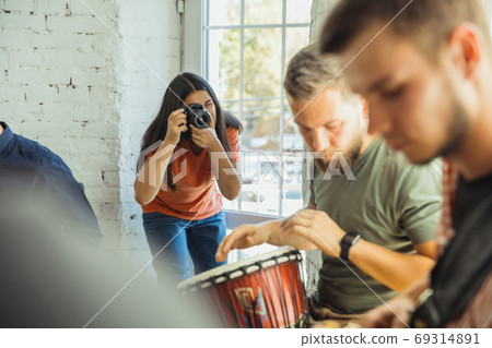 Musician band jamming together in art workplace with instruments Musician band jamming together in art workplace with instruments 69314891