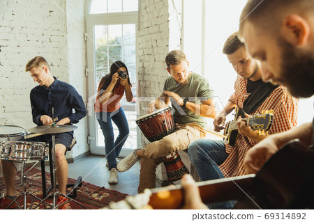 Musician band jamming together in art workplace with instruments 69314892