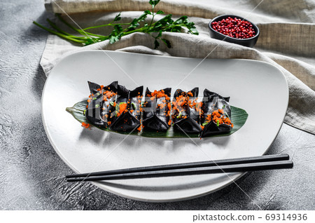 Black Dim sum dumplings. Asian cuisine. Gray background. Top view Black Dim sum dumplings. Asian cuisine. Gray background. Top view 69314936