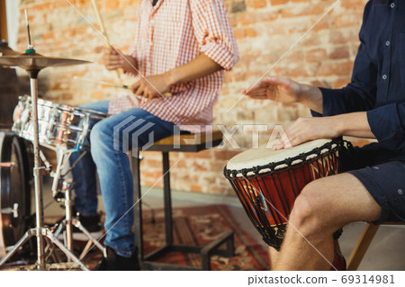 Musician band jamming together in art workplace with instruments Musician band jamming together in art workplace with instruments 69314981
