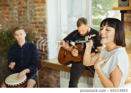 Musician band jamming together in art workplace with instruments 69314985
