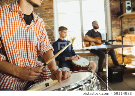 Musician band jamming together in art workplace with instruments Musician band jamming together in art workplace with instruments 69314988