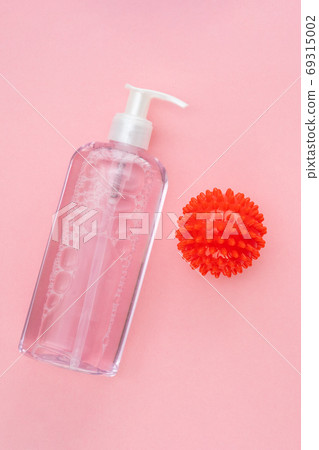 bottle of antiseptic on pink and model COVID-19 bottle of antiseptic on pink and model COVID-19 69315002