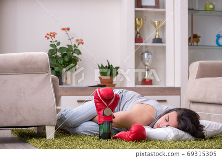 Male ex-champion boxer suffering from alcoholism at home 69315305