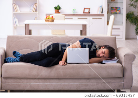 Young man employee working from house 69315457