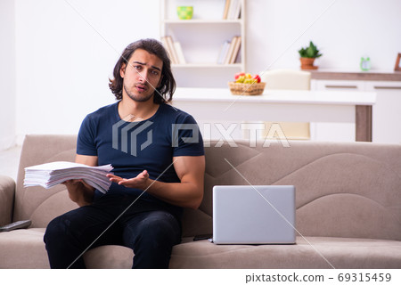 Young man employee working from house 69315459