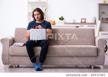 Young man employee working from house 69315465