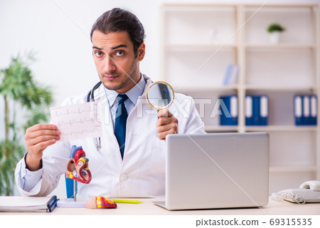 Young male handsome doctor working in the clinic Young male handsome doctor working in the clinic 69315535
