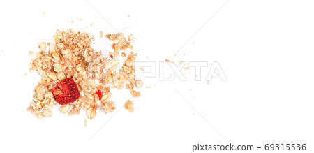 Muesli flakes with one dried strawberry, closeup photo isolated on white background space for text right side Muesli flakes with one dried strawberry, closeup photo isolated on white background space for text right side 69315536