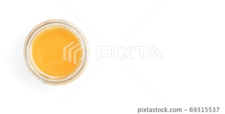 Glass jar with amber coloured honey, view from above, isolated on white background, space for text right side Glass jar with amber coloured honey, view from above, isolated on white background, space for text right side 69315537