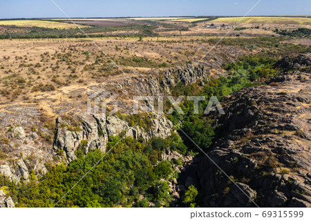 Scenic view of canyon with river and green trees on sunny day. Aktovsky canyon, Nikolaev region, Ukraine. 69315599