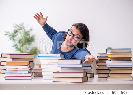 Young male student preparing for exams at home 69316054