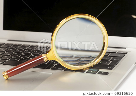 Laptop With Magnifying Glass Laptop With Magnifying Glass 69316630