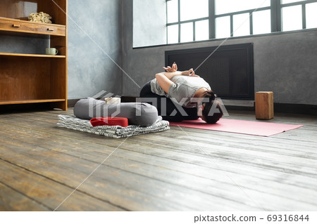 Woman doing forward bend yoga exercise, Balasana, Child Pose, stretching spin 69316844