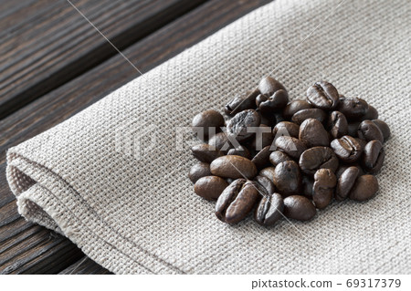 Close-up of coffee beans on linen fabric and dark Close-up of coffee beans on linen fabric and dark 69317379