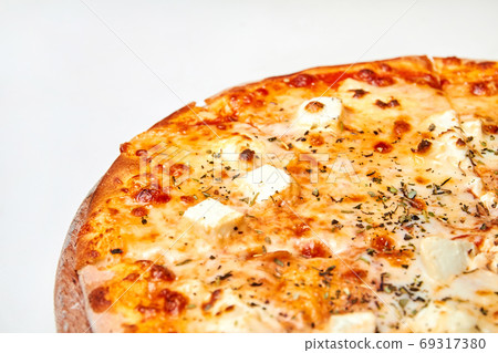 Pizza with cheese and herbs on a wooden board. Pizza with cheese and herbs on a wooden board. 69317380