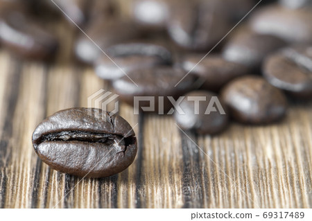 Close-up of coffee bean on dark wooden background 69317489