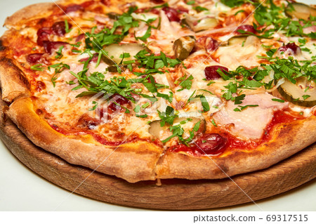 Fresh pizza with bacon, tomatoes, pickles and Fresh pizza with bacon, tomatoes, pickles and 69317515