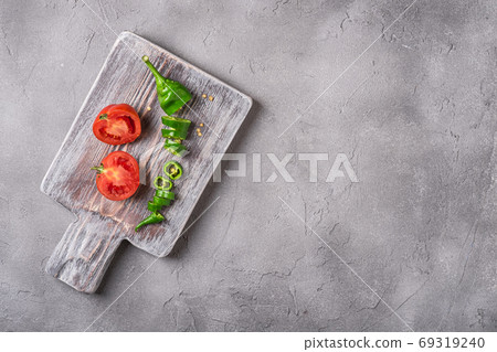 Sliced fresh ripe tomatoes with hot chili peppers Sliced fresh ripe tomatoes with hot chili peppers 69319240