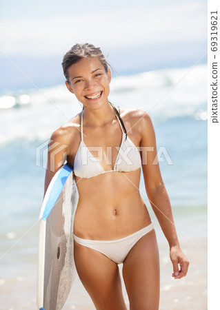 Summer beach woman having fun portrait surfing with bodyboard 69319621