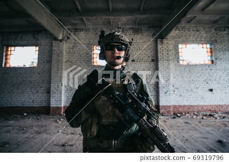 Military men with arms defending the building. Soldier stand guard securing territory looking around. Military men with arms defending the building. Soldier stand guard securing territory looking around. 69319796