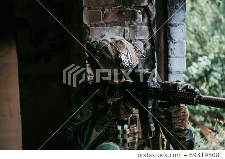 Soldier in combat. Urban combat training, soldier entering abandoned building. Anti terrorist operation battlefield training. 69319808