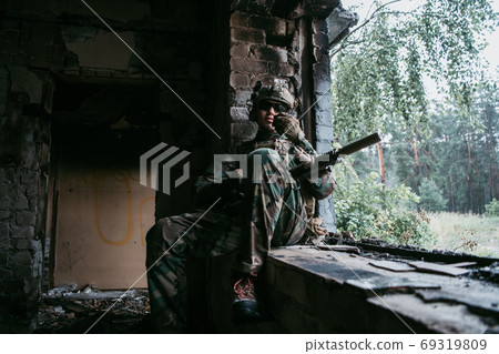 Soldier preparing tactical gear for action battle Soldier preparing tactical gear for action battle 69319809