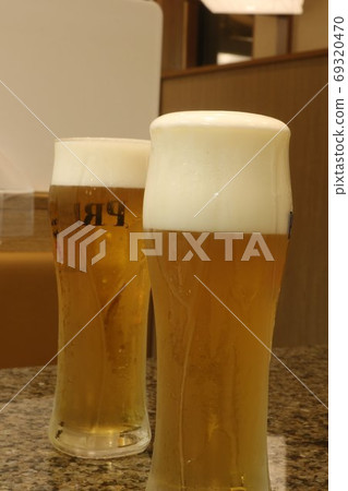 Beer poured into a cup 69320470