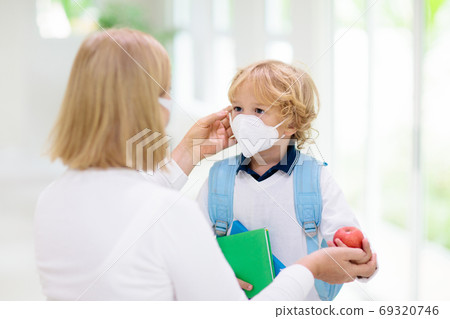 Mother and child with face mask and hand sanitizer 69320746