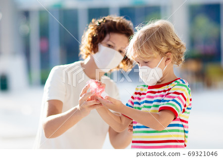 Mother and child with face mask and hand sanitizer Mother and child with face mask and hand sanitizer 69321046