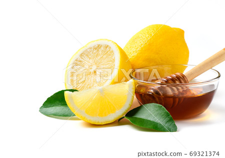 Fresh lemon with leaf and honey with honey dipper isolated on wh 69321374