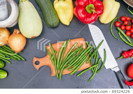 chopped green beans on a wood board with vegetables one 69324226