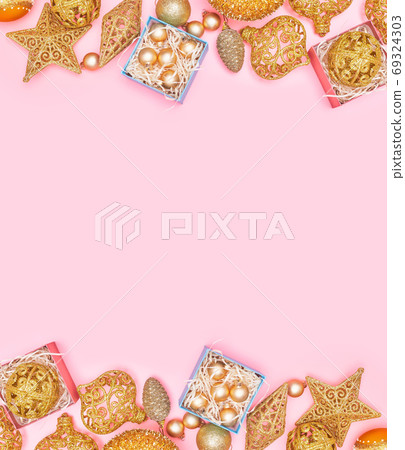 golden christmas decoration on pastel pink background, copyspace, layout 69324303