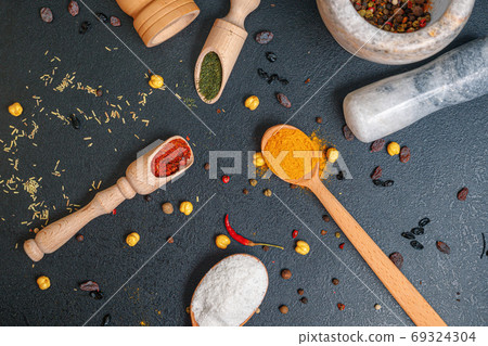 wooden spoons with colorful spices on the table, top view 69324304