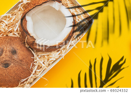in a box coconut on a yellow background isolate, copyspace, layout 69324332