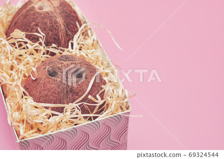 in a box coconut on a pink background isolate, copyspace in a box coconut on a pink background isolate, copyspace 69324544