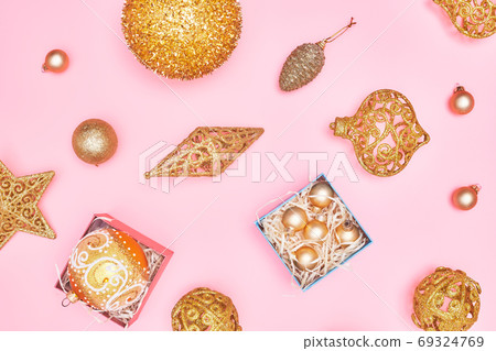 golden christmas decoration on pastel pink background, copyspace, layout 69324769