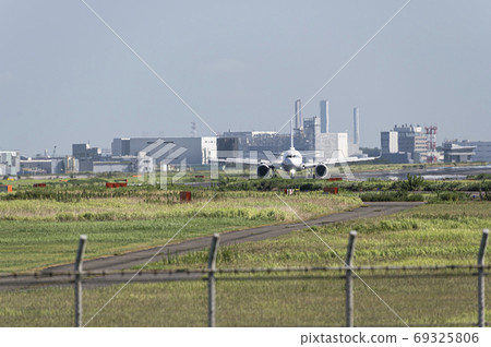 A passenger plane landing on the midsummer runway at Haneda Airport where the mayfly rises 69325806