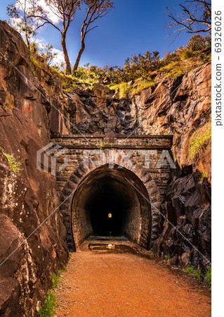 Old mountain tunnel surrounded by rocks Old mountain tunnel surrounded by rocks 69326026
