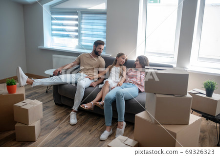 Family resting on the sofa after discussing something 69326323
