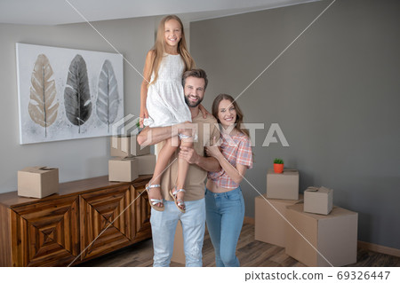 Parents and daughter spending time together at home Parents and daughter spending time together at home 69326447