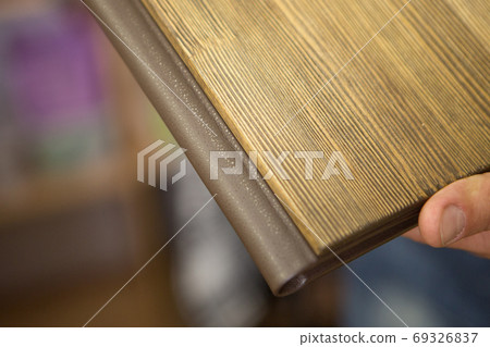 Diary close-up on a beige background. the cover is made of wood. the best gift - a photo album 69326837