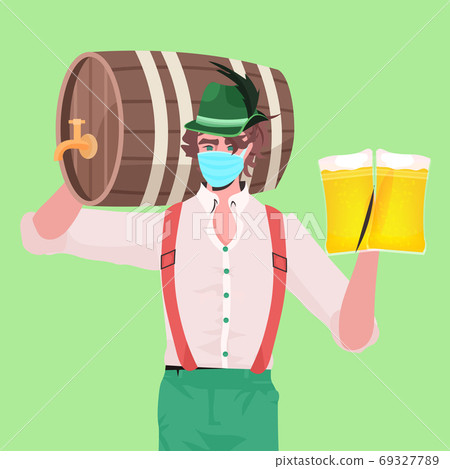 man in medical mask holding beer mugs and barrel Oktoberfest party celebration coronavirus quarantine man in medical mask holding beer mugs and barrel Oktoberfest party celebration coronavirus quarantine 69327789