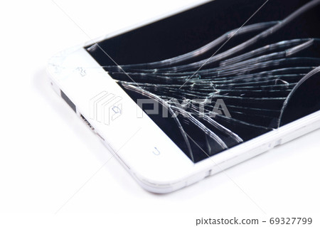 White phone with a broken screen on a white White phone with a broken screen on a white 69327799