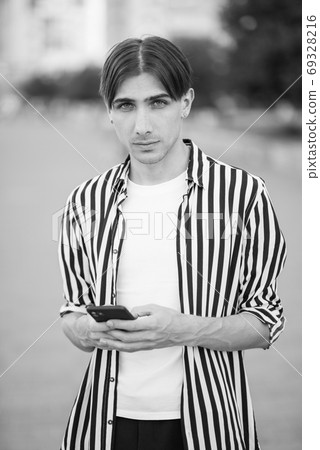 Portrait of a gay man - member of the LGBTQ community. Black and white photo. BW 69328216