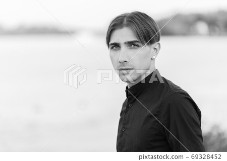 Portrait of a gay man - member of the LGBTQ community. Black and white photo. BW Portrait of a gay man - member of the LGBTQ community. Black and white photo. BW 69328452